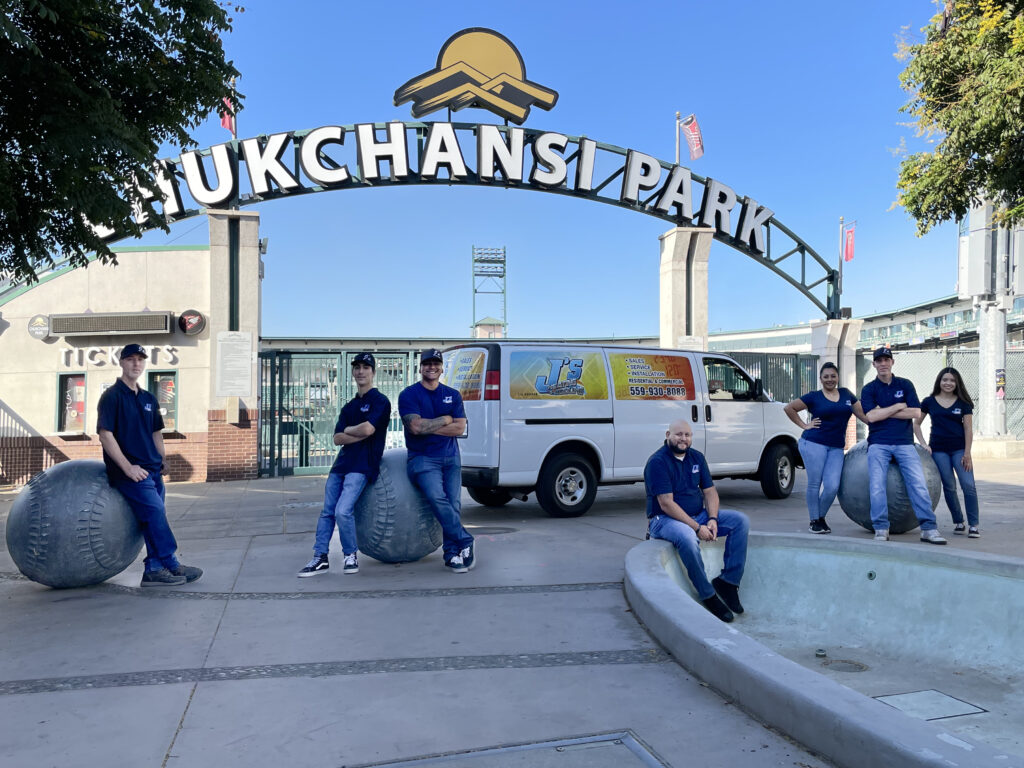 J's Heating and Cooling team photo at baseball stadium in Fresno chukchansi.